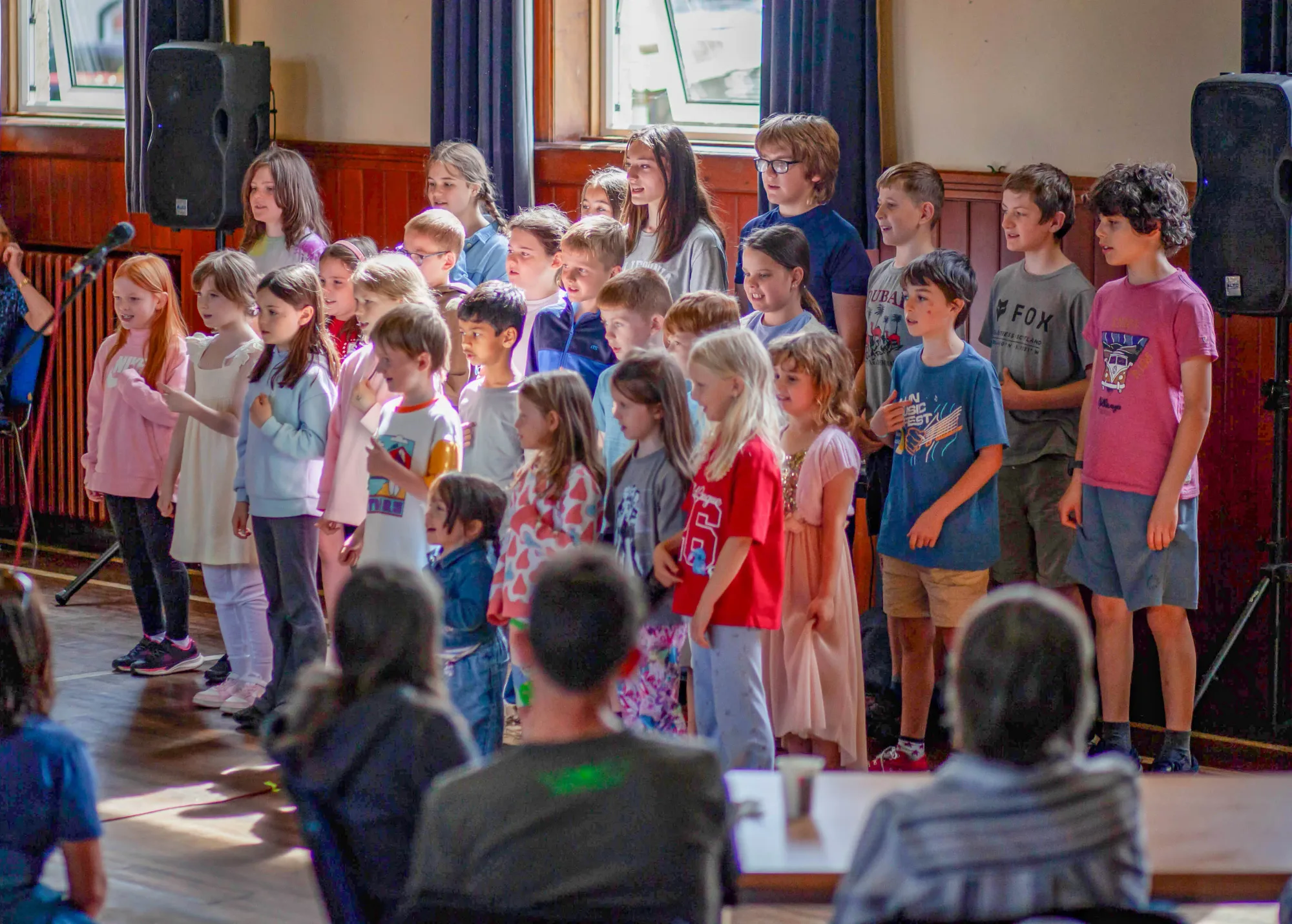 The primary school choir singing to a full hall at the Sunday community day