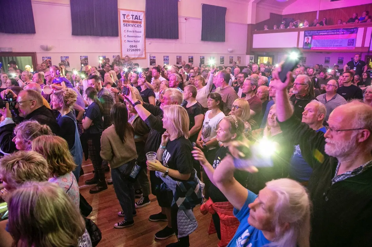 Crowd with phone torches at McLaren Hall